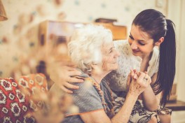 Two women hug. 