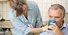 Therapist and patient practicing swallowing exercises.