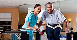 Therapist and patient working on balancing exercises.