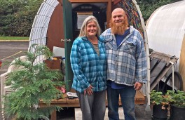 Tracy Joscelyn and Red Showers, onsite managers, stand outside their hut. As members of the program, they now help manage the site. 